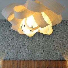 pendant lamp in front of floral wallpaper